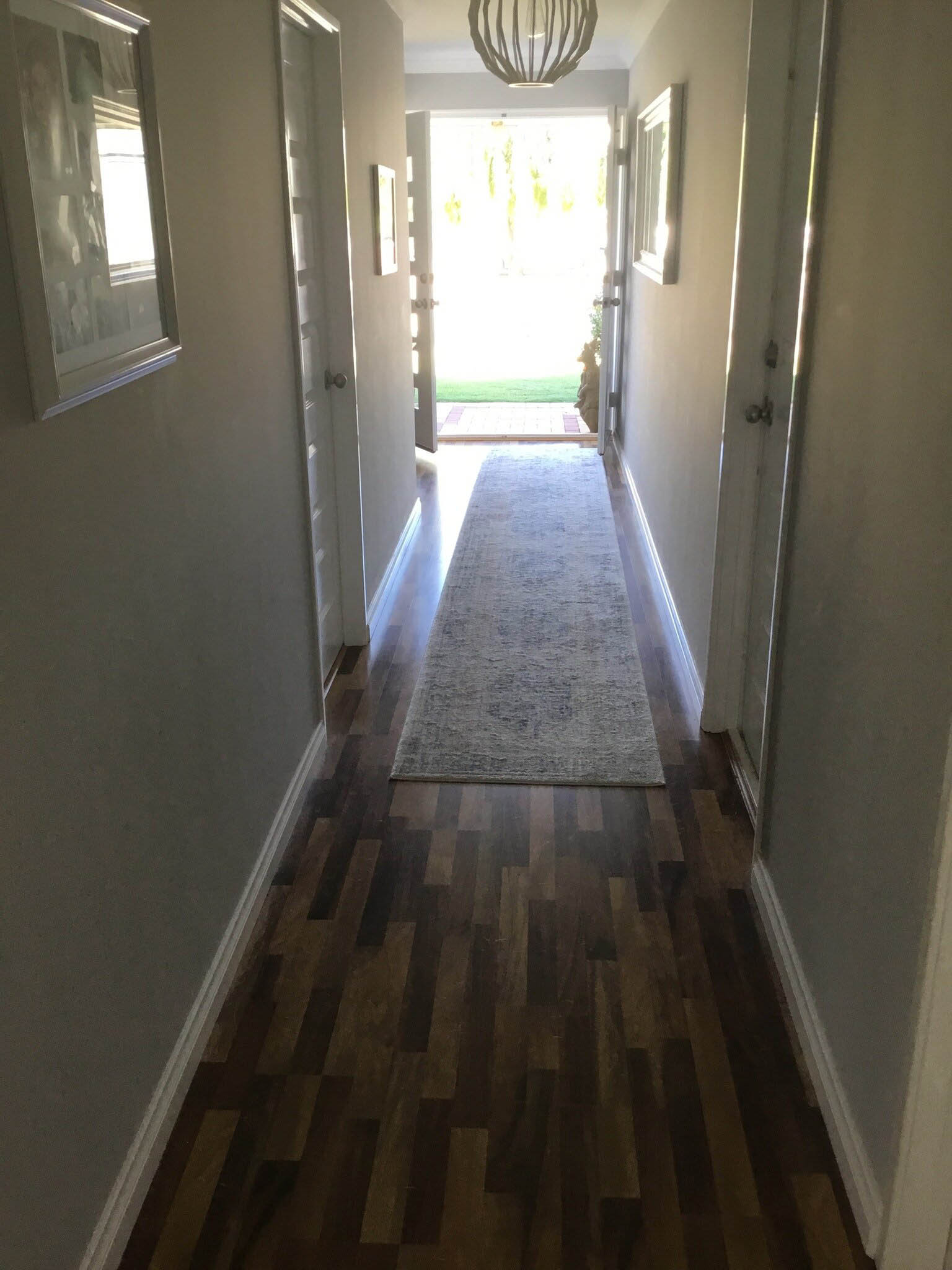 Hallway with a dark timber floor and a long runner rug