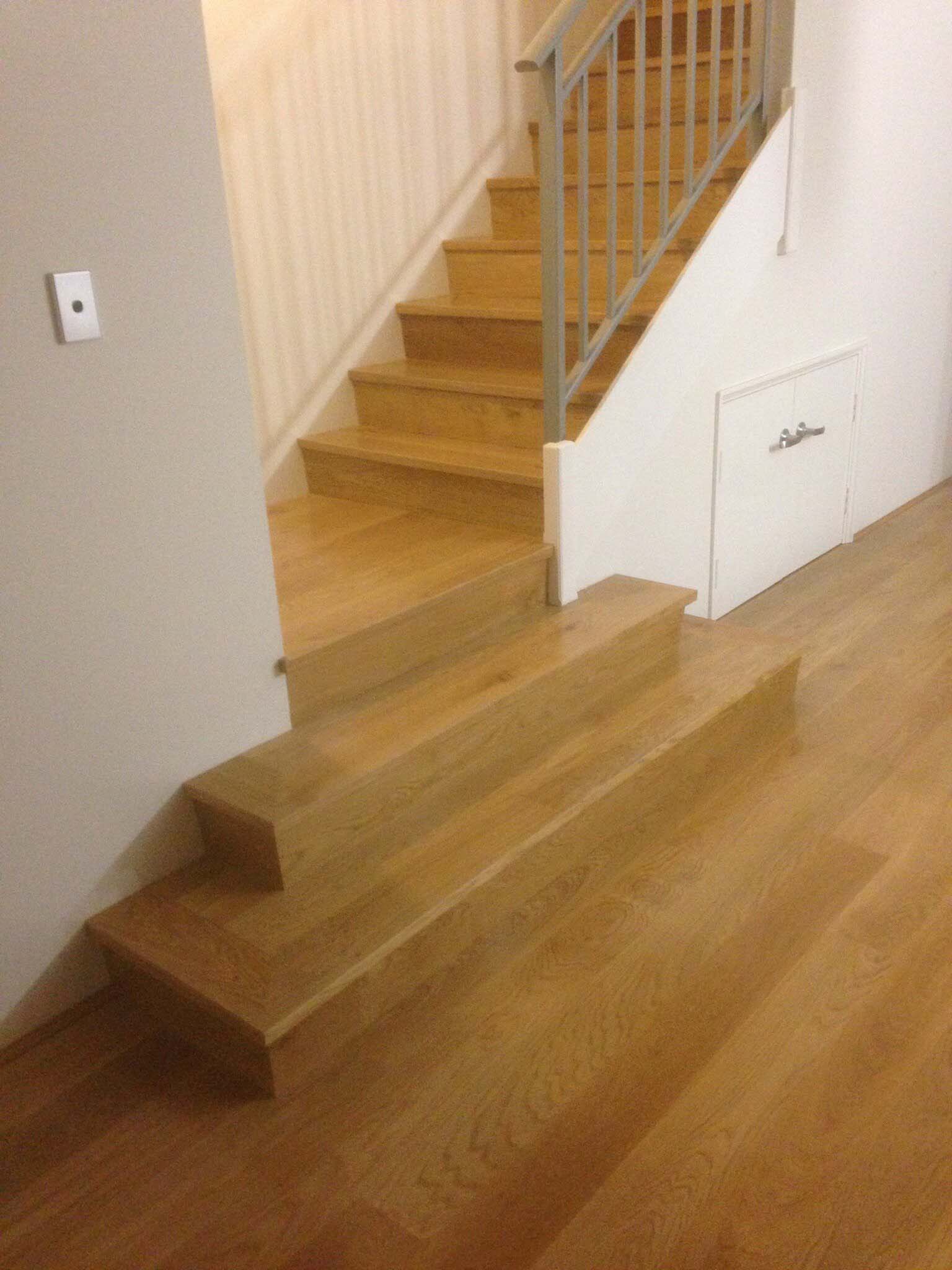 Timber staircase with matching timber floor and a metal balustrade