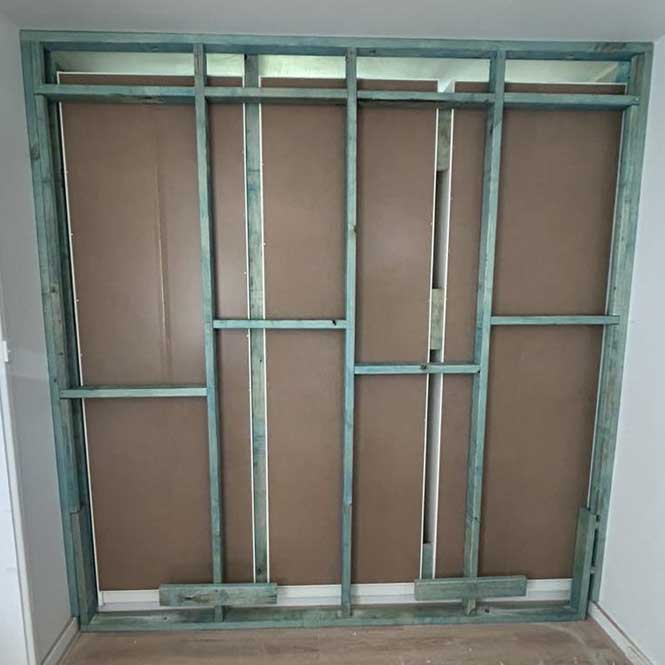 Timber stud wall frame built into a wall opening