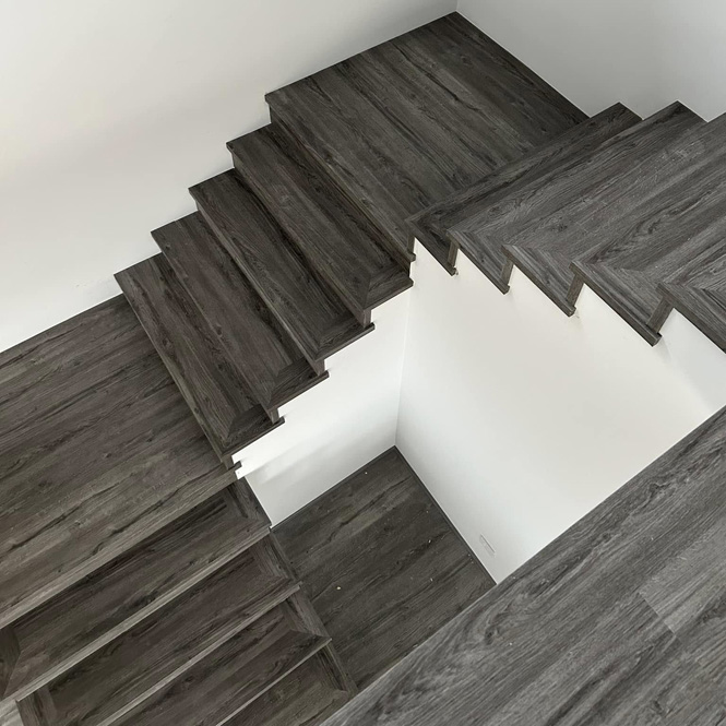 Grey timber-look staircase seen from above