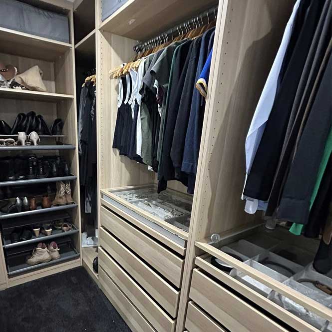 Walk-in wardrobe with hanging rails, shoe shelves and drawers